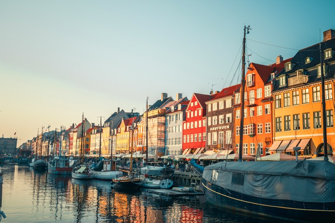 Fishing boats docked at a quiet Danish harbor at dawn