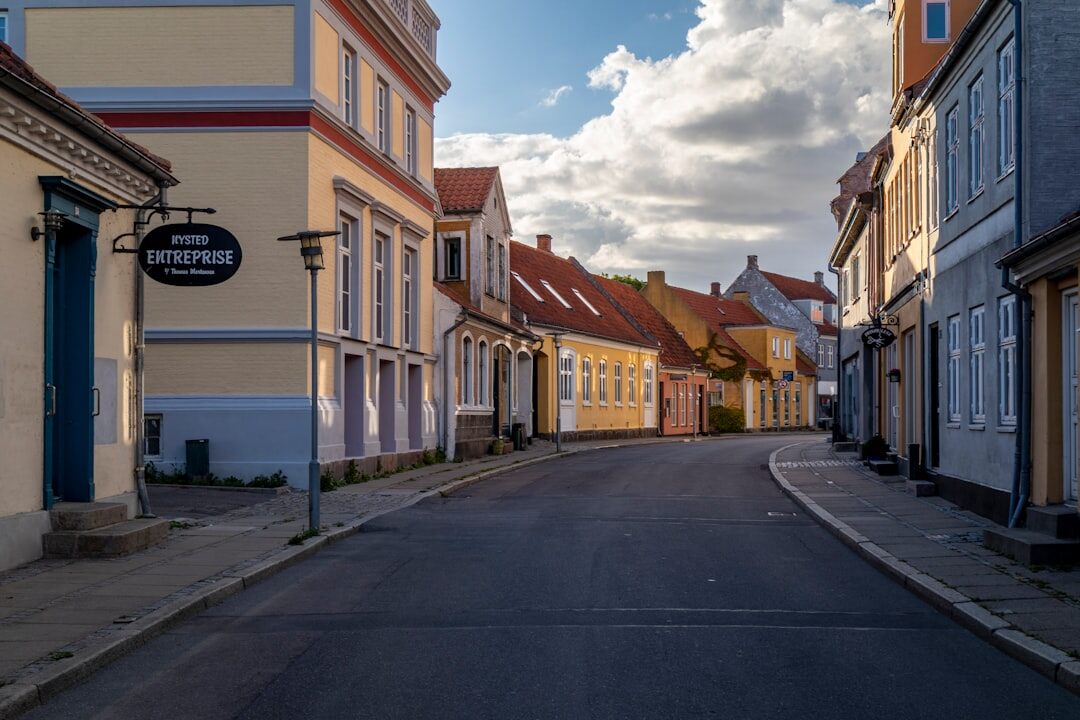 Empty cobblestone street with colorful traditional Danish houses in morning light